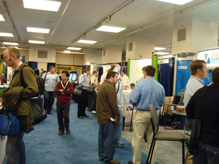 the group of people is talking at the trade fair