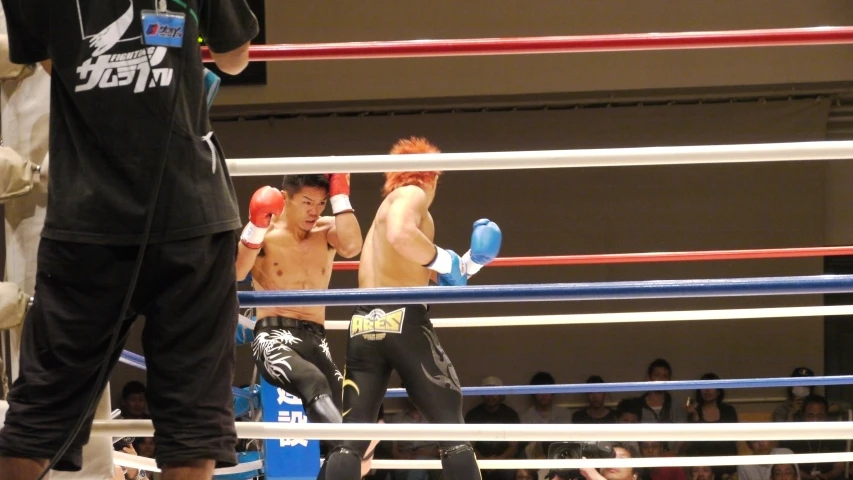 a man throws a punch at an opponent during a professional boxing match