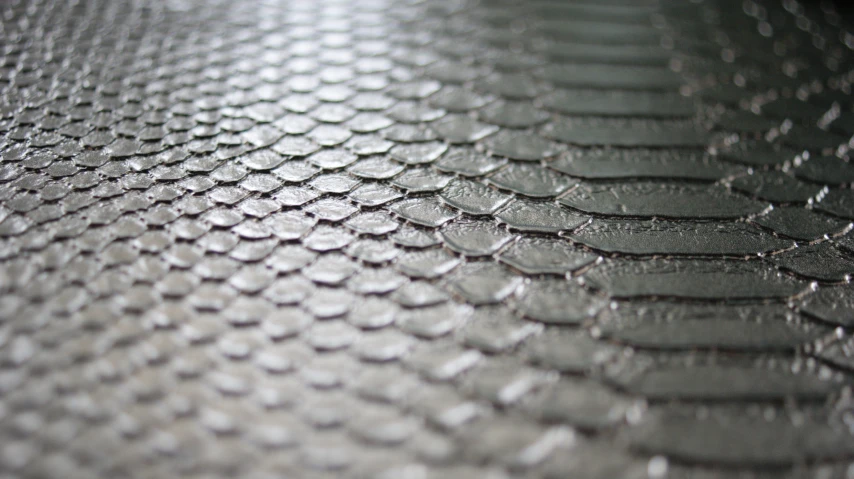the top half of a metallic surface with shiny patterns