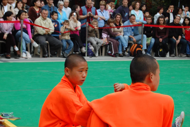 two s standing in front of a crowd