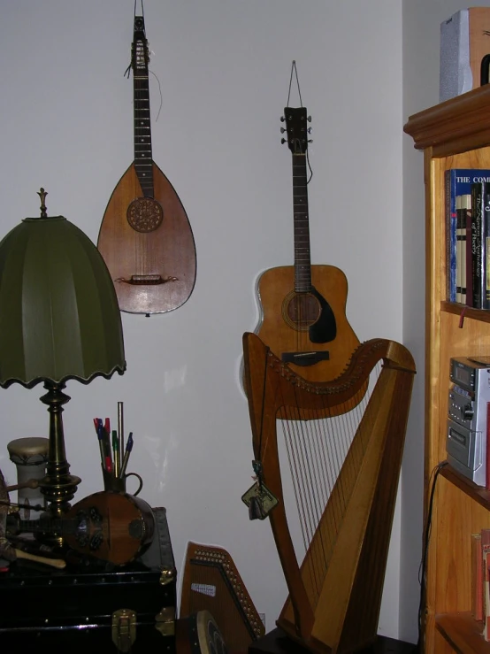 a couple of guitars are on a shelf