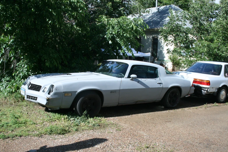 two cars parked near each other near a street