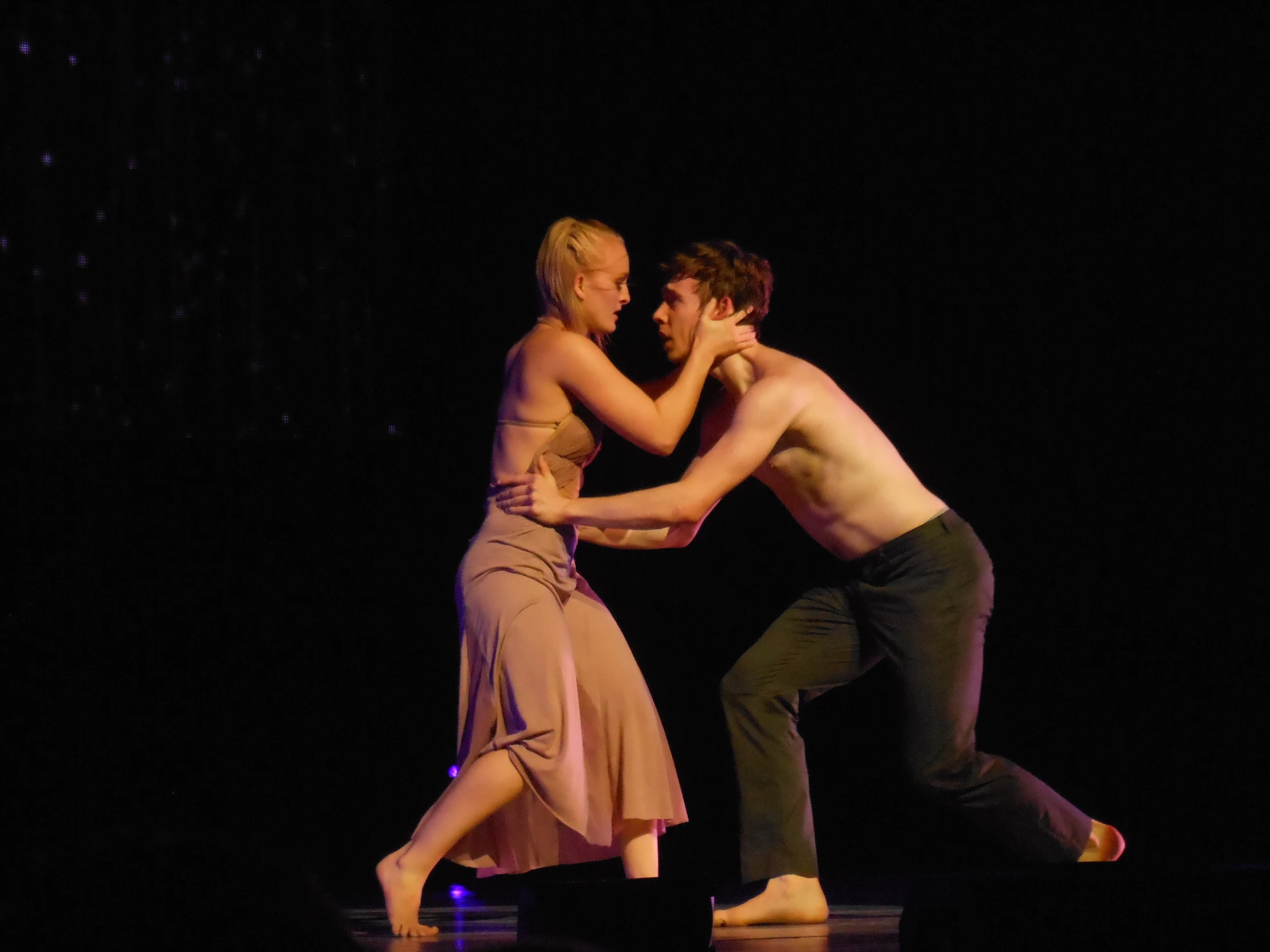 a man and a woman dancing on stage