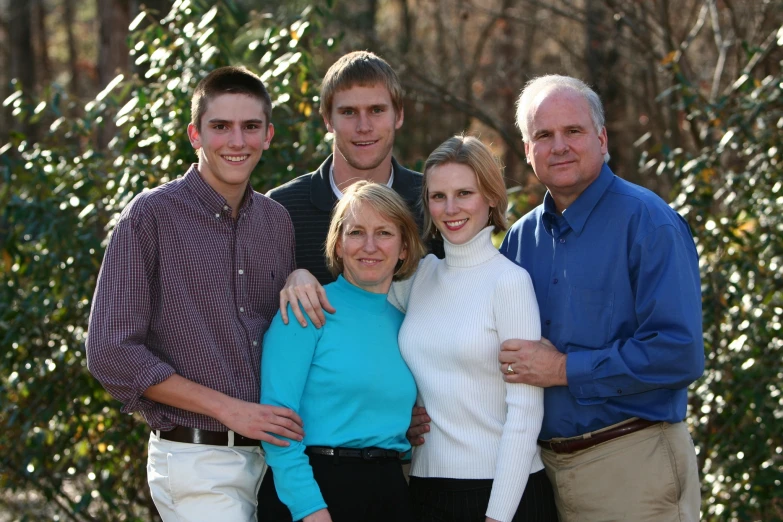 a group of friends are posing for a family po