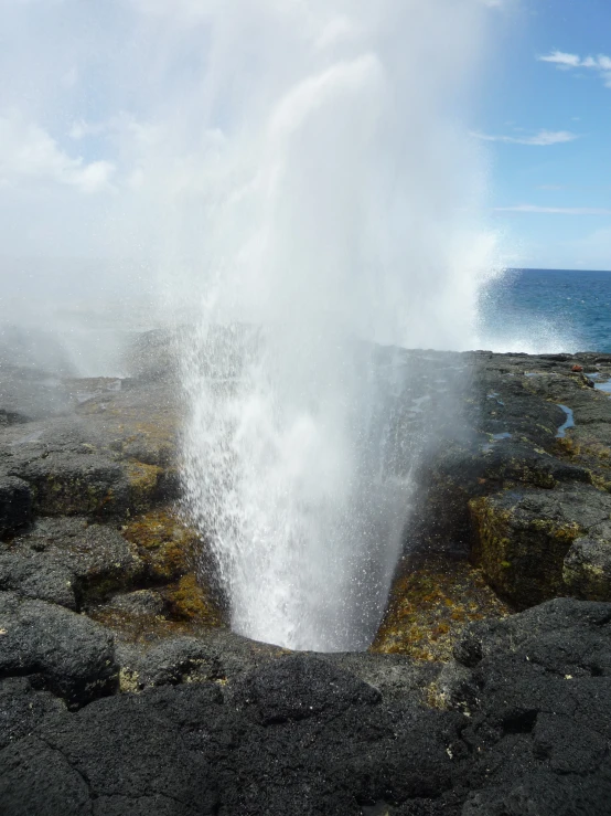 an open pit that is pouring water into the air