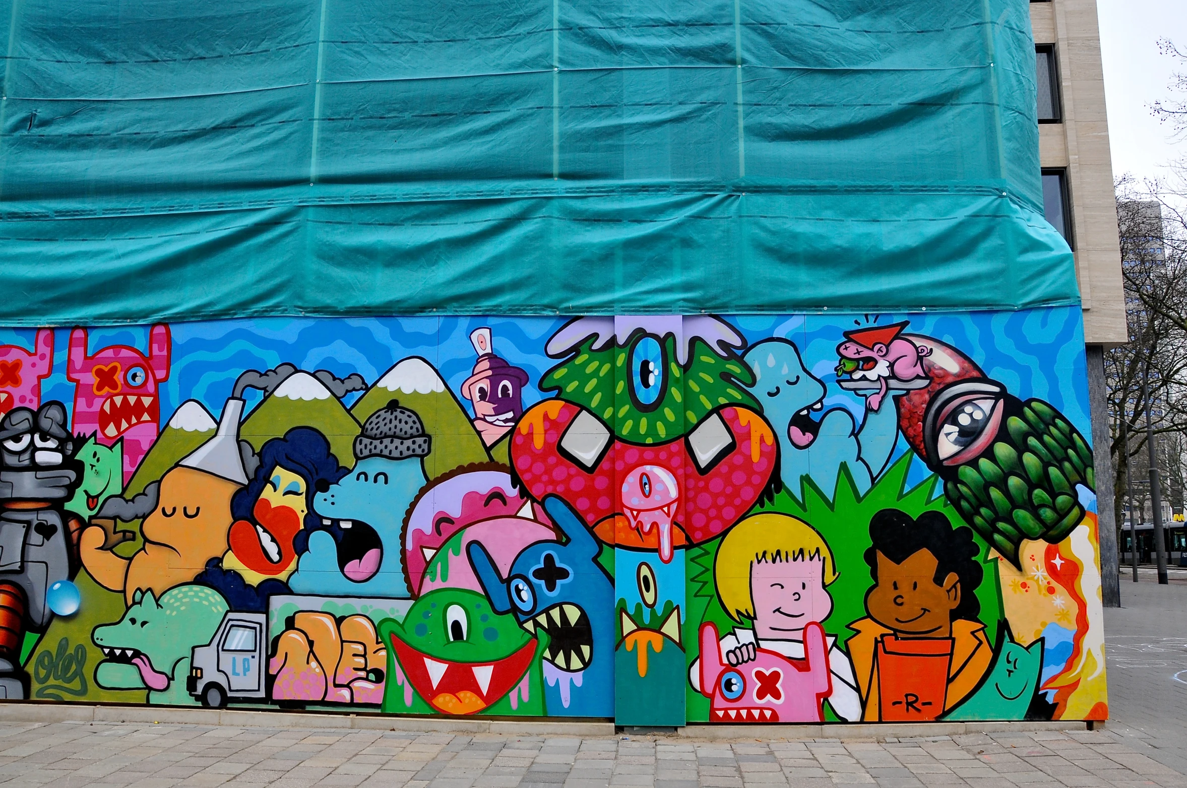 colorful graffiti artwork with many heads on a building