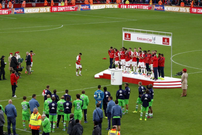 soccer players huddle together on the sidelines for a group po