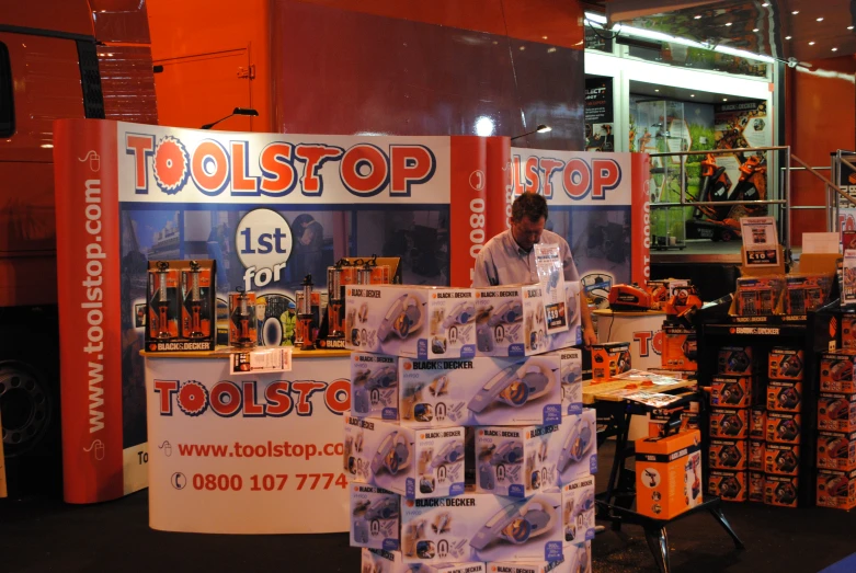 a man standing next to stacks of tools