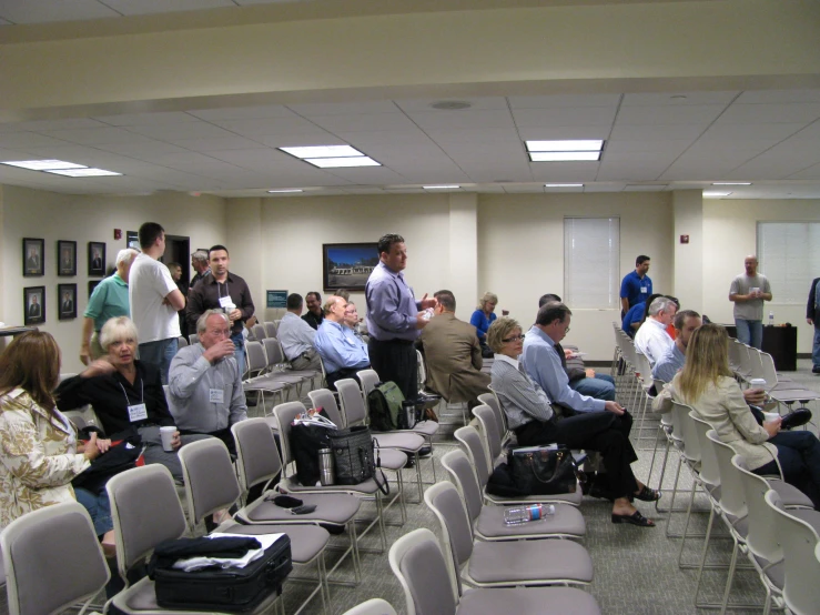 a conference room filled with a large number of people