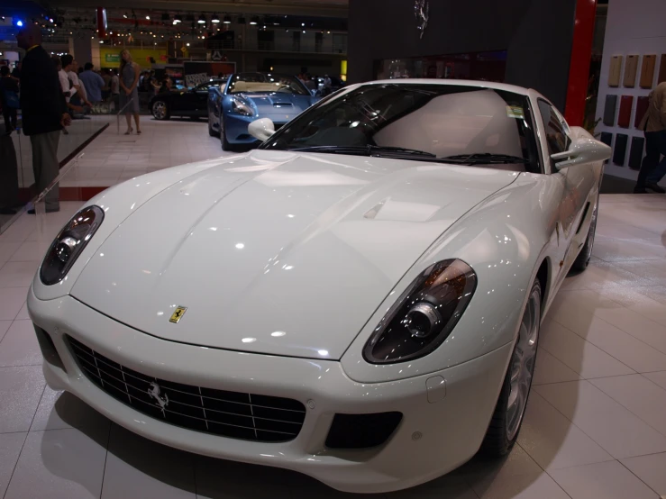 the front view of a white car at an event