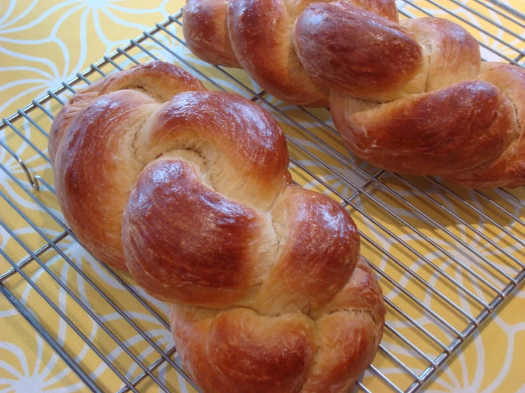 some croissants on a cooling rack with yellow background