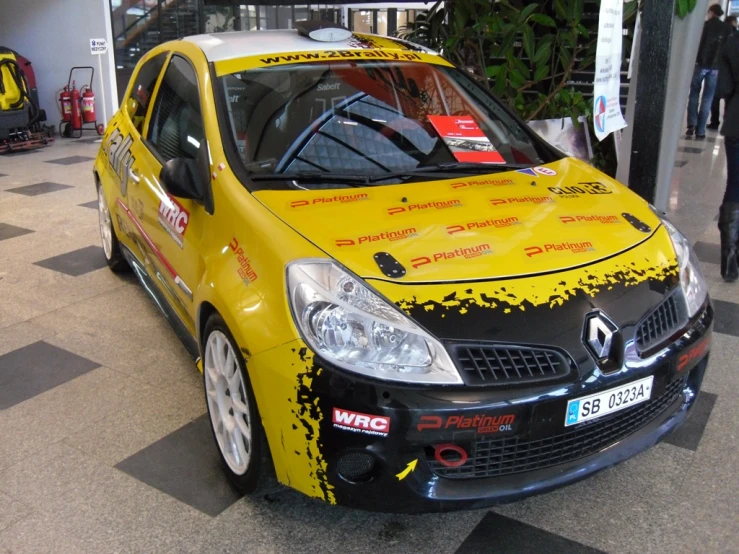 a yellow and black car that has a number on it