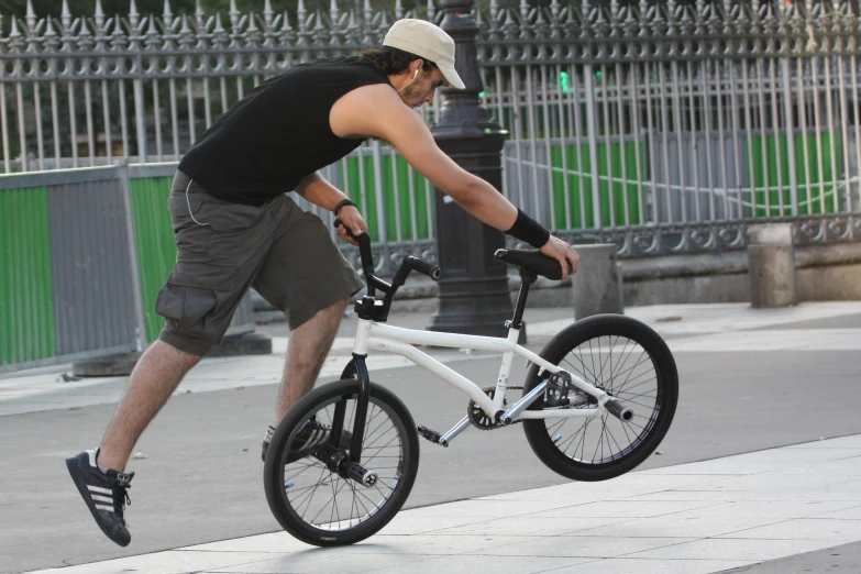 a man riding a white bike in the street