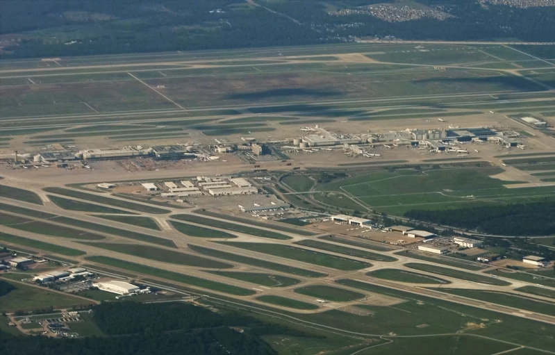 an aerial view of airplanes with an airport in the background