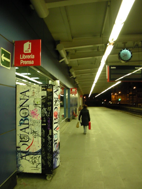 an image of an empty train station with graffiti on the side