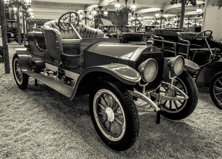 an antique car sits on display in the room