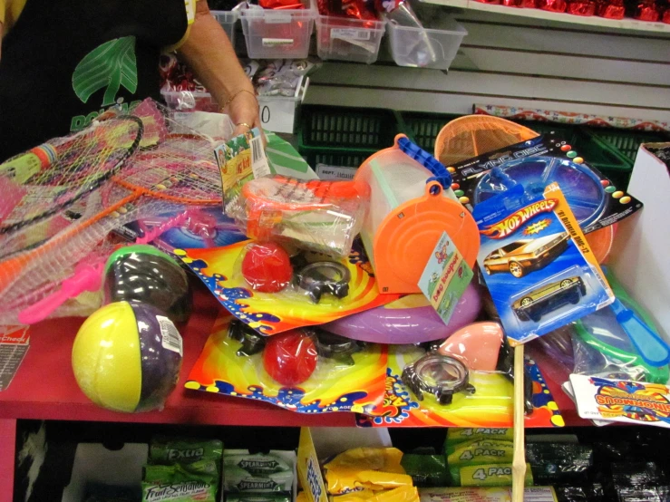 a table filled with toys and lots of bags