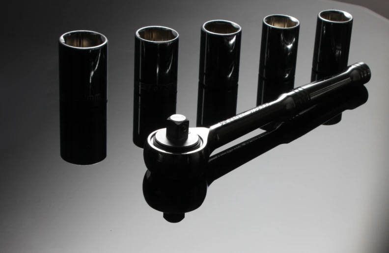 an assortment of black rollers sit on a table