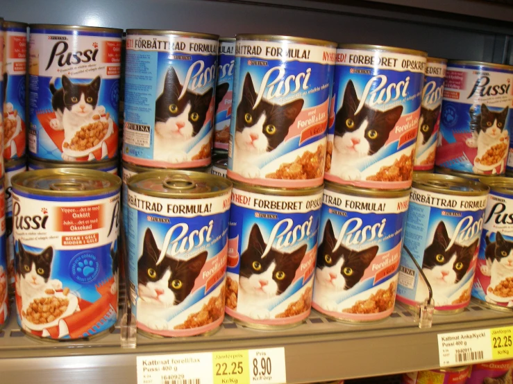 many cans of cat food stacked up on a shelf