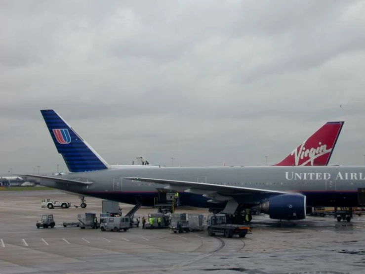 two planes are parked on the tarmac at an airport