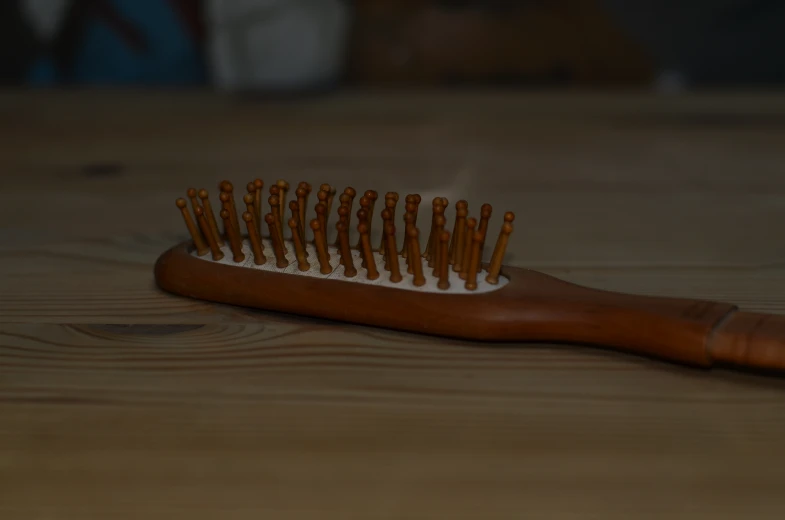 a wooden brush sitting on top of a table