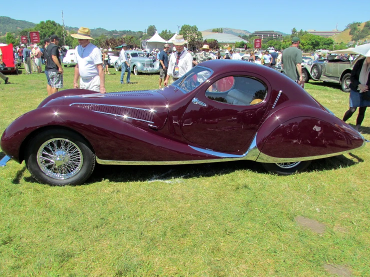 an old car that is on some grass