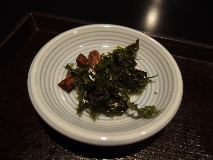a white plate with seaweed on it