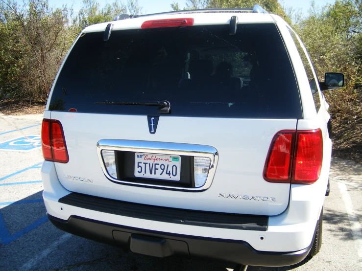 a white dodge van with a black license number plate