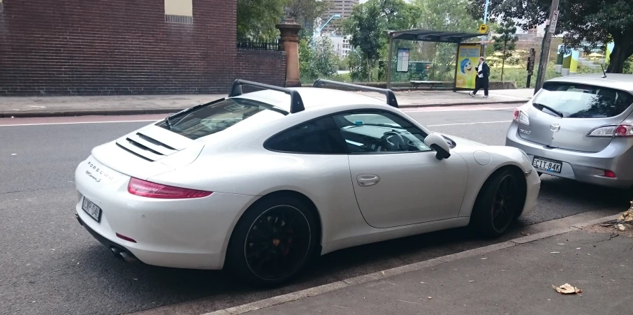 a white car parked next to another silver car