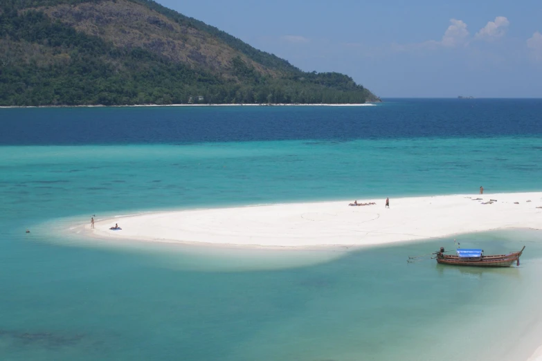 people on the beach on a tropical island