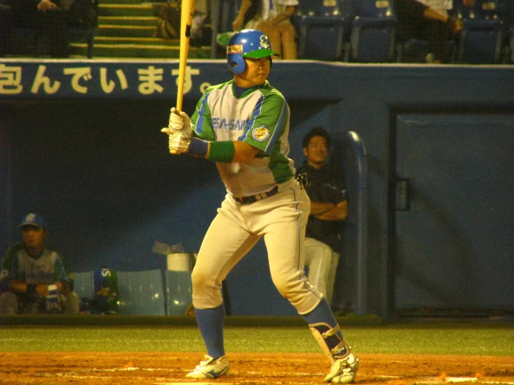 a baseball player holding a bat standing in a field