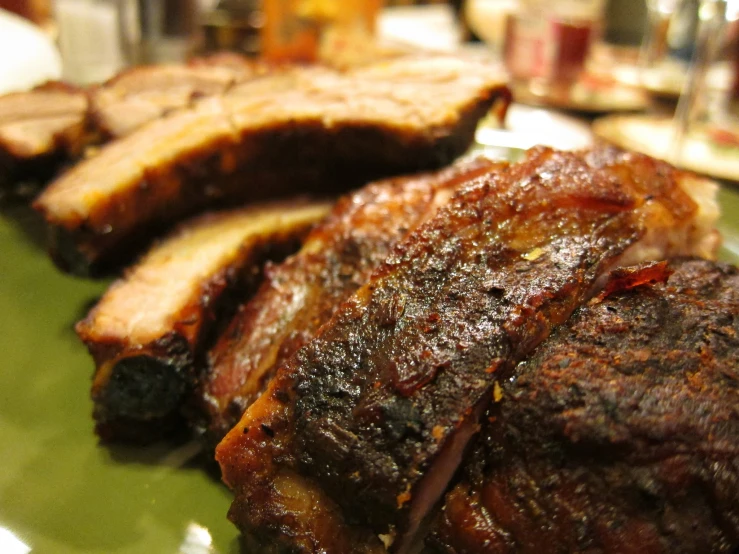 pork steak on a plate, with a fork, and some glasses