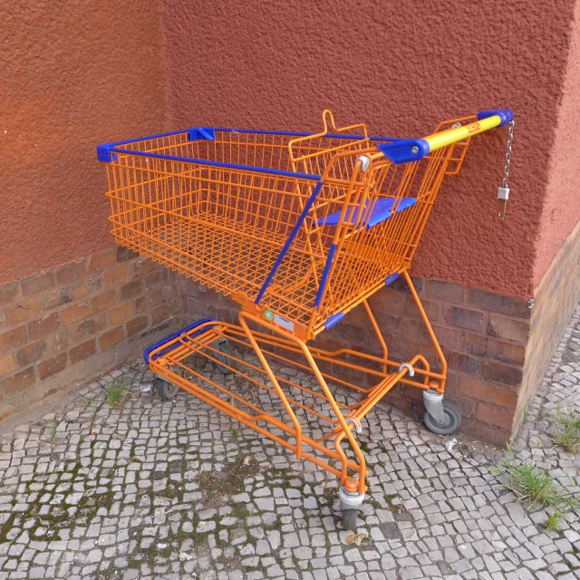 an orange cart sitting in front of a building