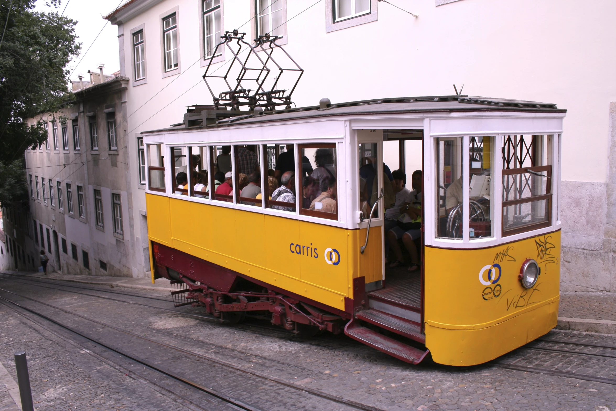 people are riding inside of a small yellow tram