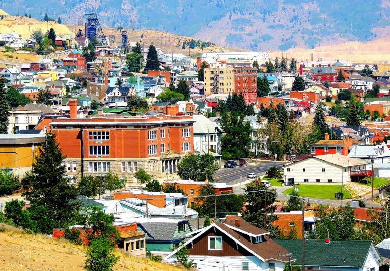 an urban area with buildings and hills in the background