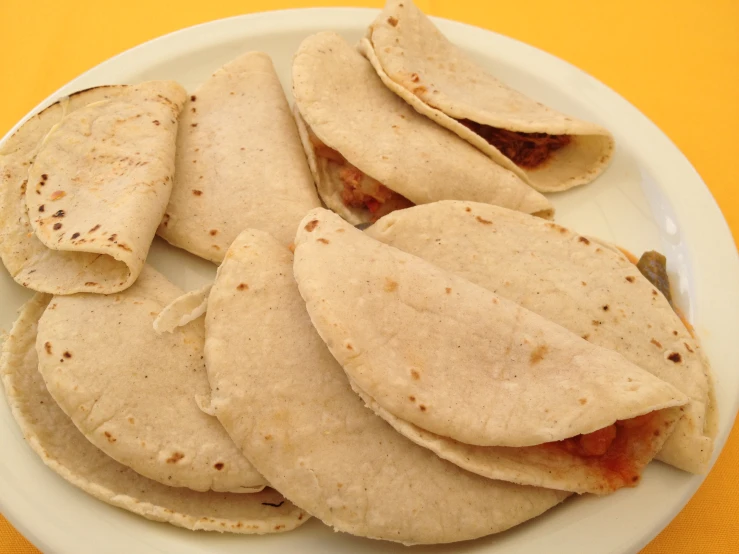 a plate topped with tortilla shells covered in burnt meat