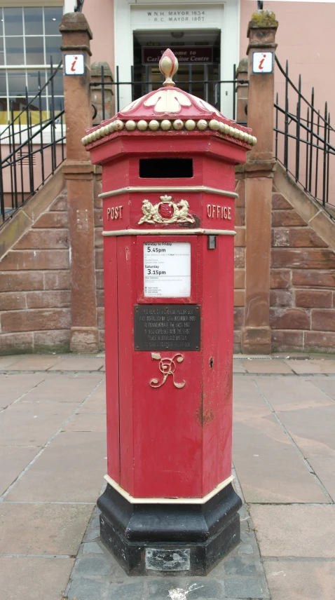 a red post office is located near the gate