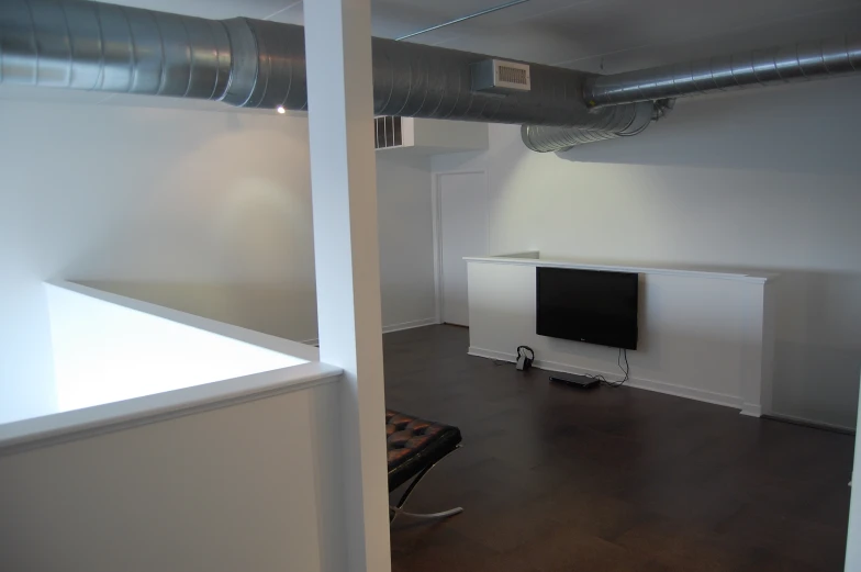 an empty room with a small television next to the wall