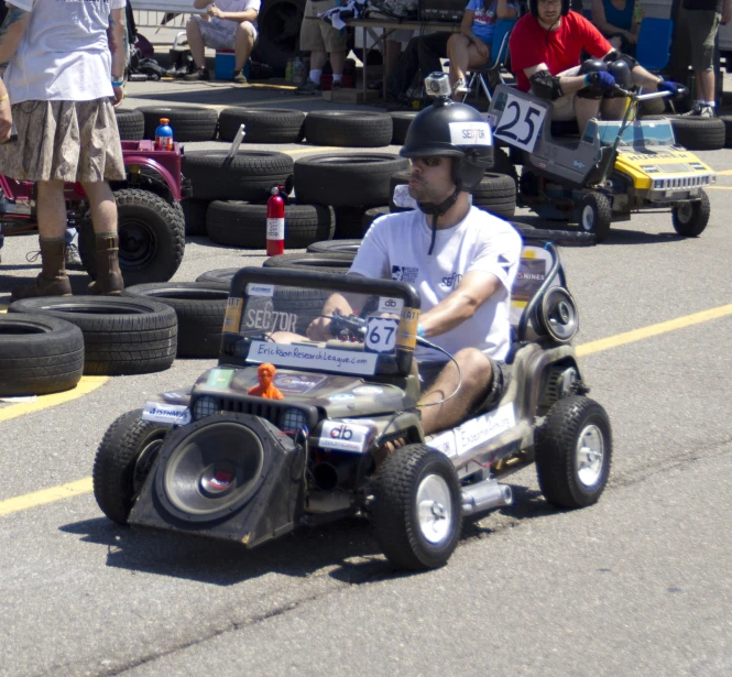 man in white shirt riding motorized device down street