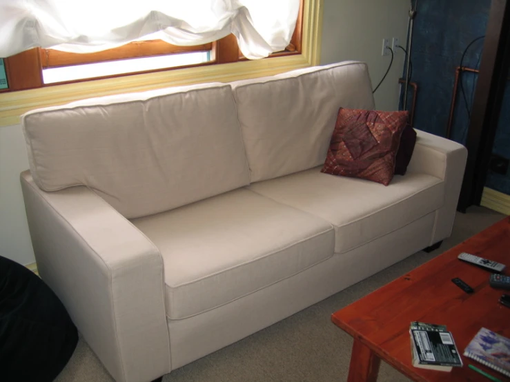 a close - up view of a sofa next to the window