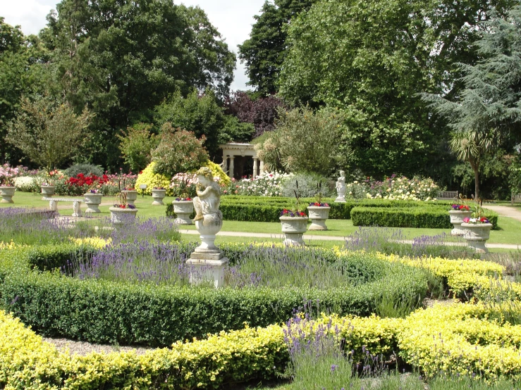 a garden has an ornamental garden surrounded by flowers and shrubbery