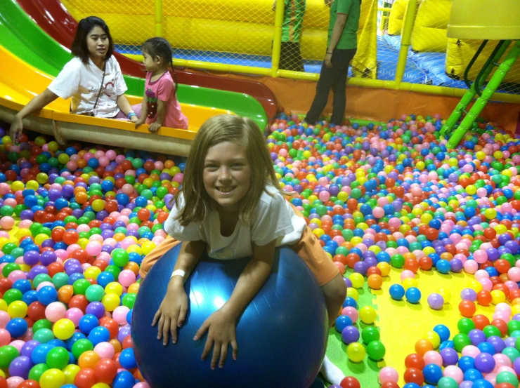 a  riding a ball inside a splash park