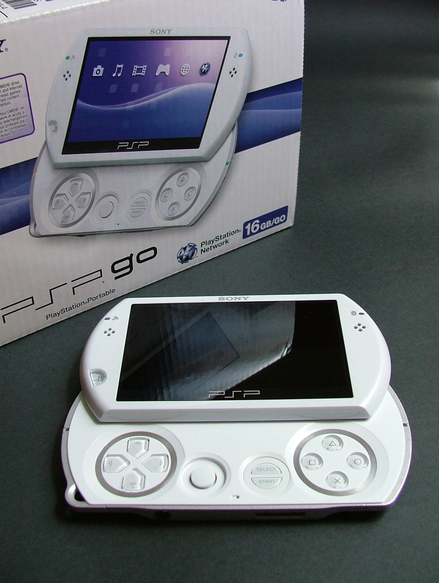 a white electronic device with a built in screen and a case