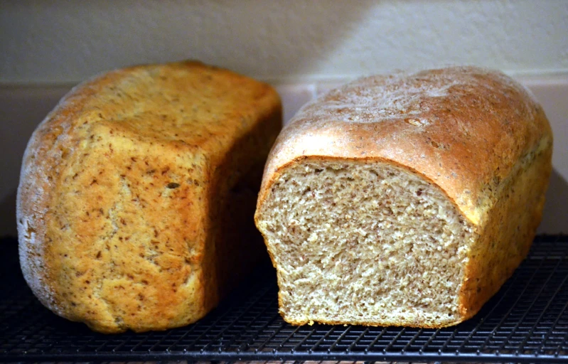 a pair of white bread sitting on top of a wire rack