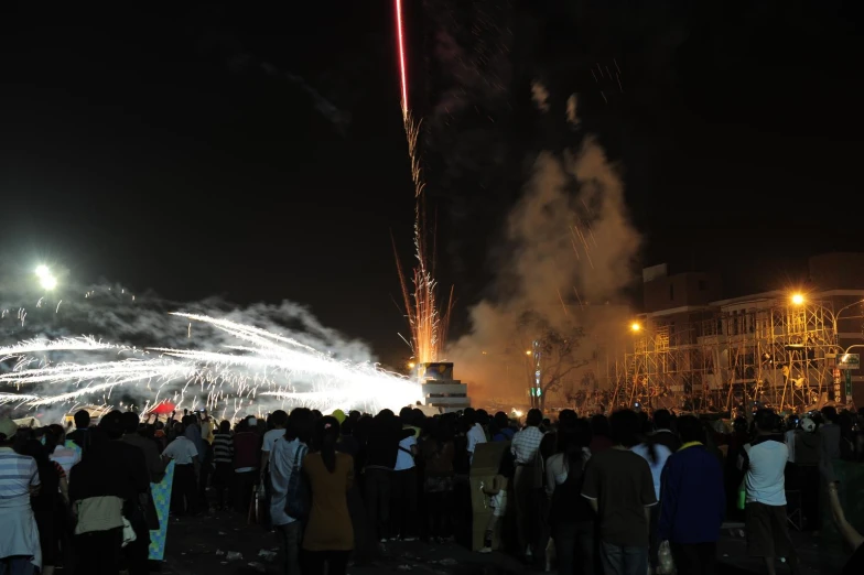 people gathered in the middle of a large city at night