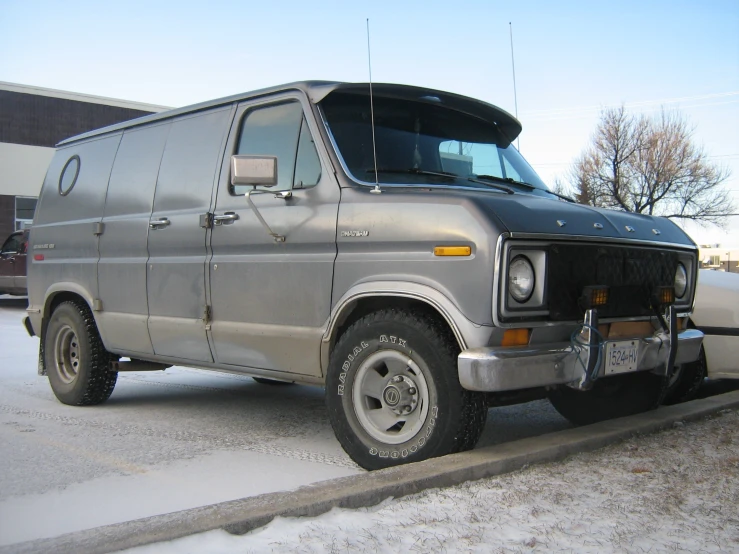 a van parked in a parking lot with its door open