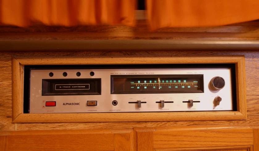 a white clock and radio in a wooden frame