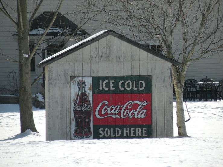there is a shack shaped ice cold soda stand in the snow