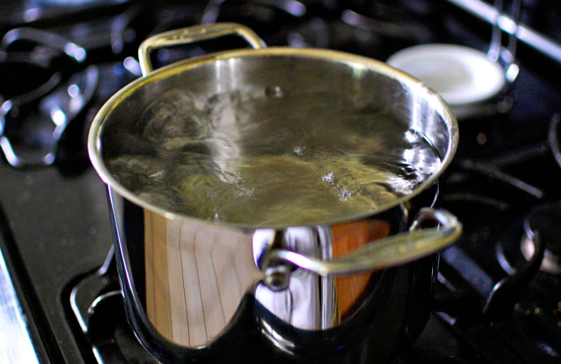 an image of a pot with cooking utensils on top