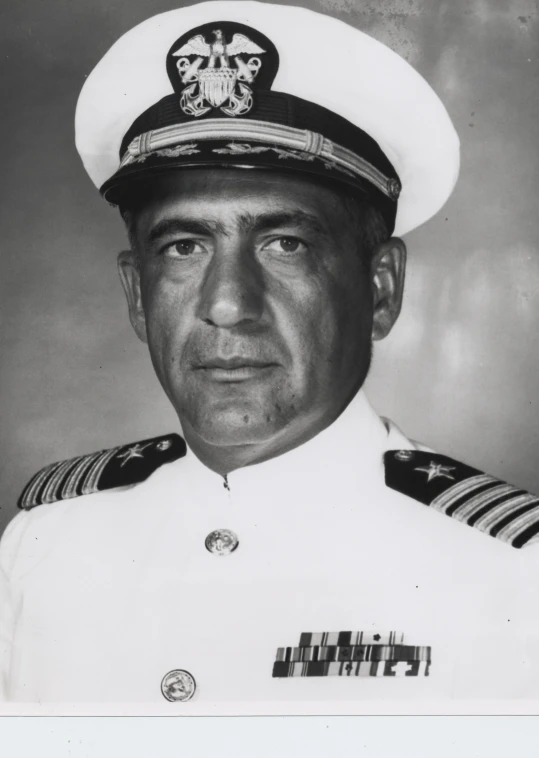 a naval official wears a white uniform